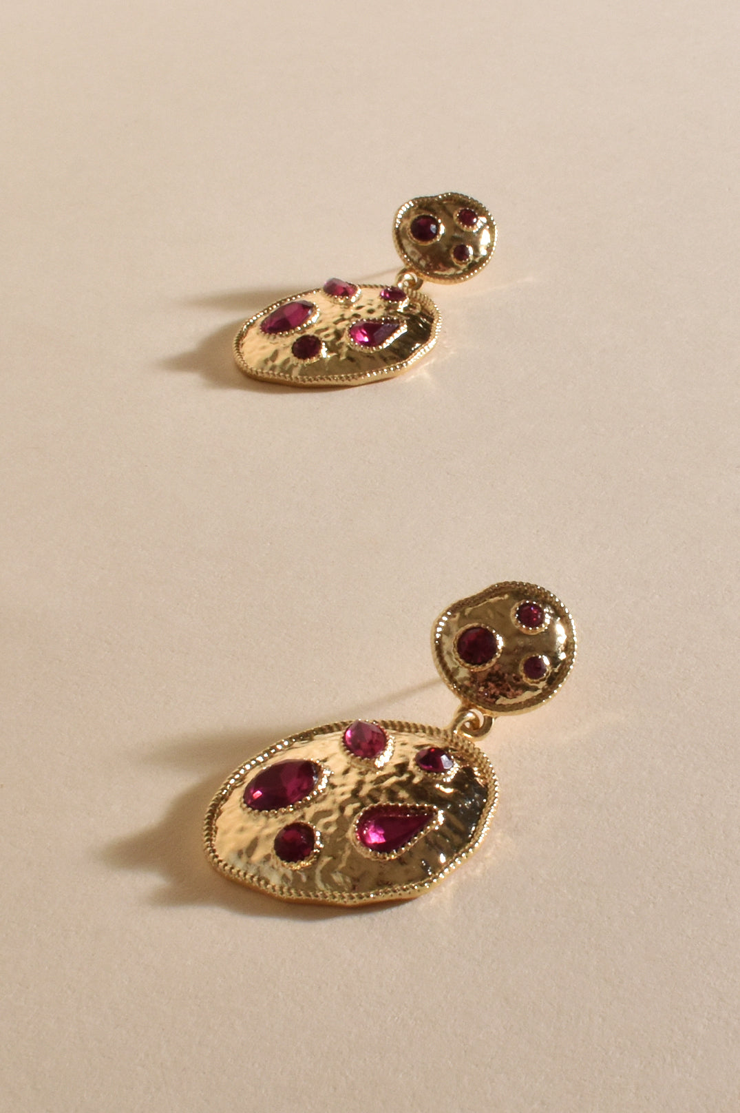 Jeweled Metal Disc Earrings with Magenta stone detail.